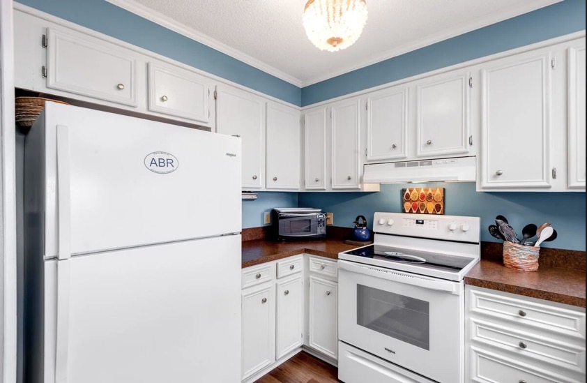 White kitchen cabinets and appliances at Island Beach & Racquet Club B302