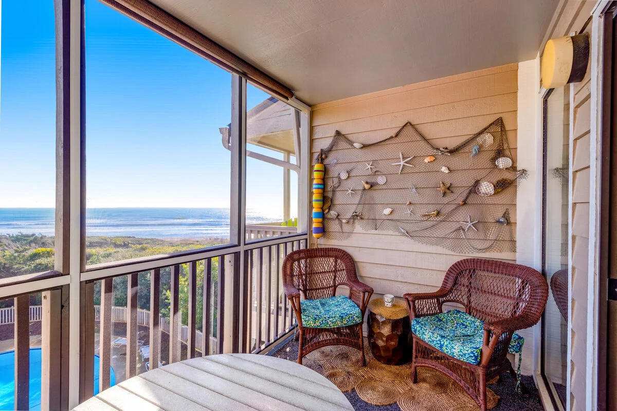 Screened porch with an ocean view at Island Beach & Racquet Club B302