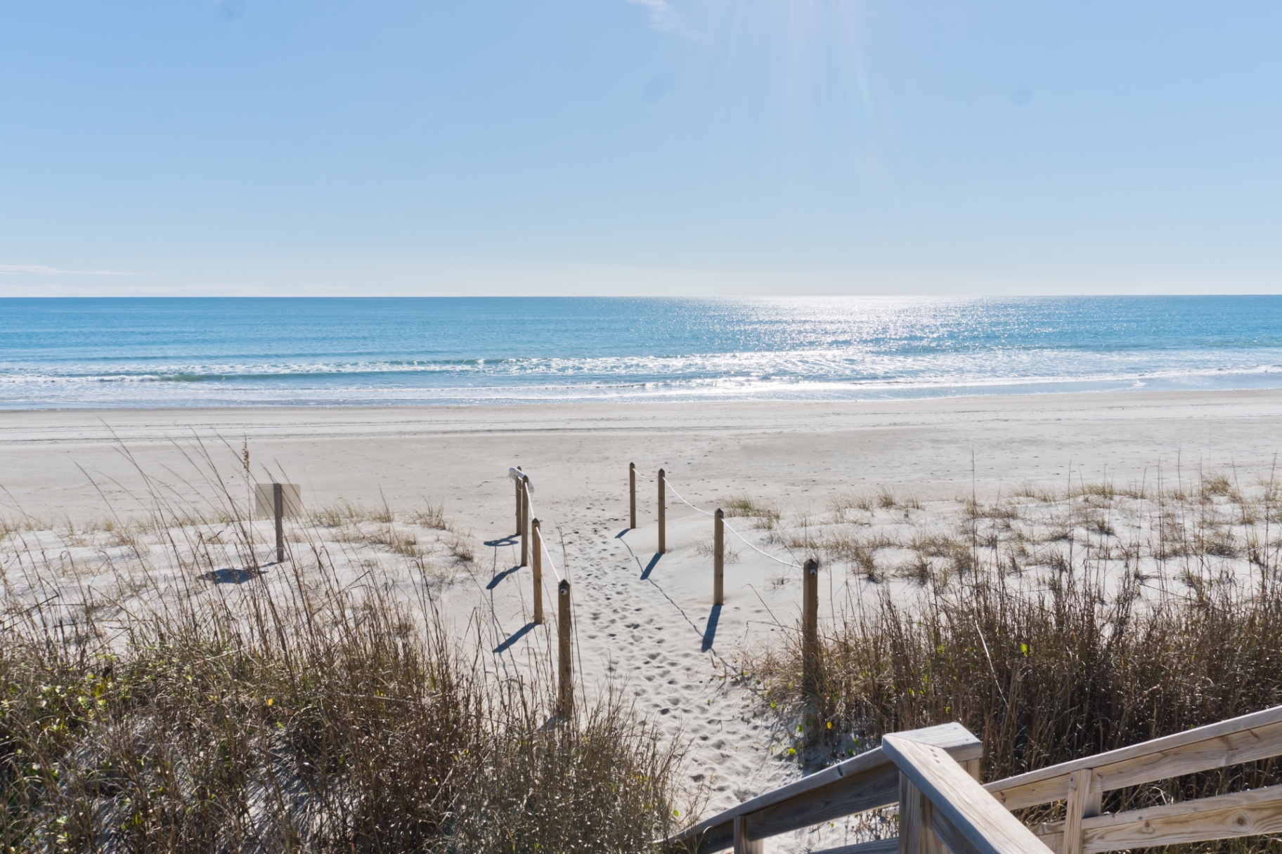 Sandy beach access path leading to the ocean at Coral Shores 12